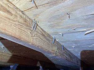 Roof sheathing attached with staples